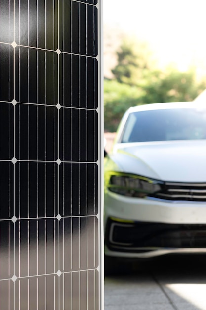 Vertical view of blurred modern white electric car powered with solar panels in focus as renewable e