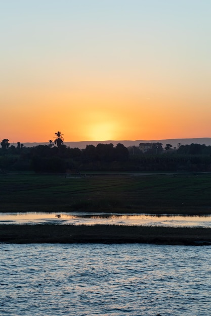 Vertical view of landscape on the banks of the Nile river Egypt Africa during sunset time