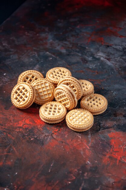 Vertical view of tasty sugar cookies on mix colors background with free space