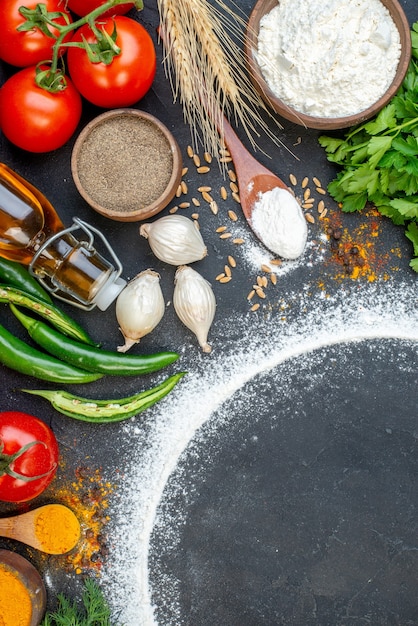 Vertical view of various fresh foods set with flour around