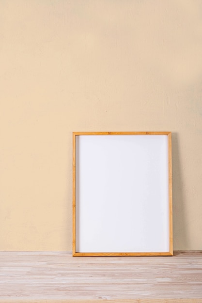 Vertical wood frame mock up on wooden floor and Light brown background