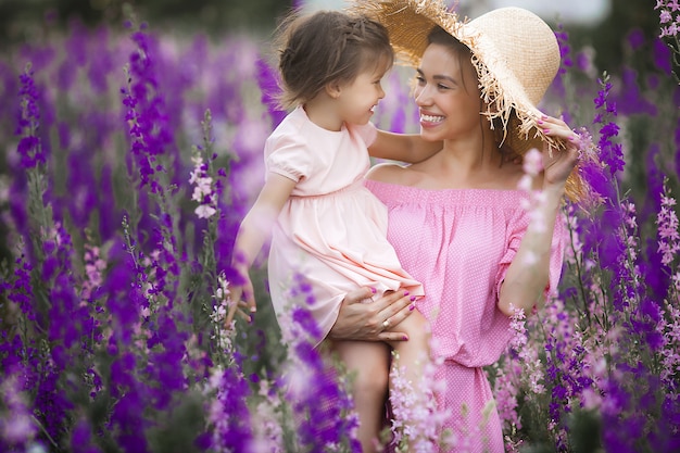 Very beautiful picture of young mother and child in the flower field