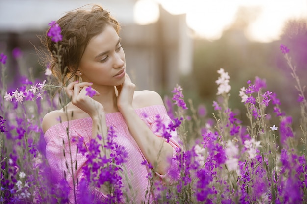 Very beautiful young woman with flowers. Close up portrait of attractive female