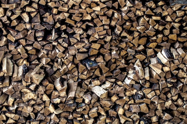 very large pile of firewood, stacked in an old barn