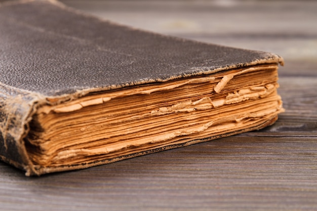 Very old book close-up. Grey desk background.