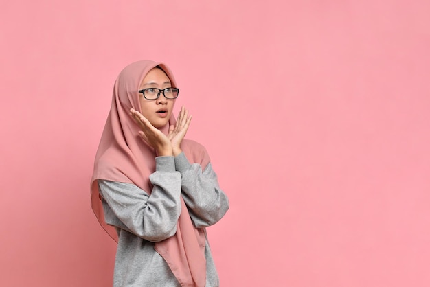 Very surprised Young Asian muslim woman shocking look at product on sale promotion discount big sale