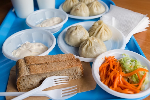 A very tasty lunch at a roadside cafe the national food of the Mongols Buryats Meat in the dough and salad