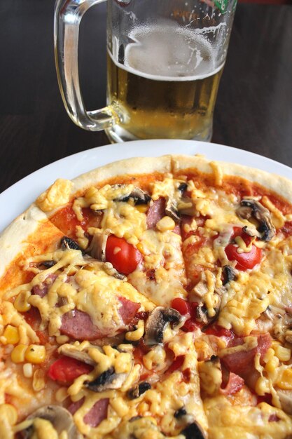 Very tasty pizza with glass of fresh beer