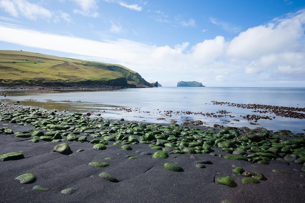 Vestmannaeyjar island beach view with Alsey island in background Iceland landscape