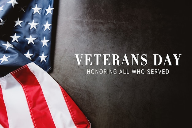 Veterans day. Honoring all who served. American flag on gray background with copy space.