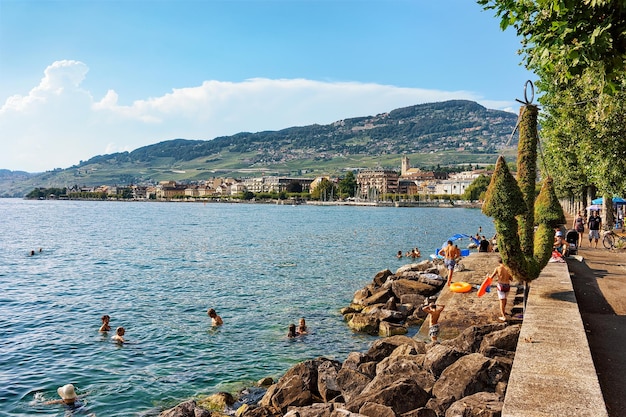 Vevey, Switzerland - August 27, 2016: People swimming at the embankment of Geneva Lake in Vevey, Vaud canton, Switzerland