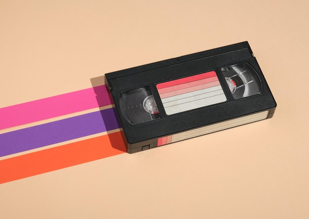 VHS video cassette on pastel background with colored stripes Minimalistic retro composition