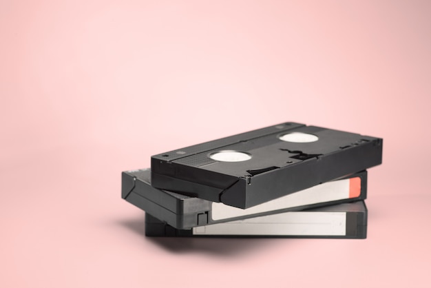 VHS video tape on a pink background