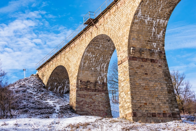 Viaduct in Plebanivka village, Terebovlyanskiy district of Ukraine, on a sunny winter day