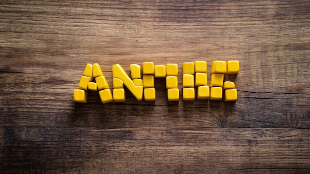 Photo vibrant anemia word created from yellow cubes on wooden table