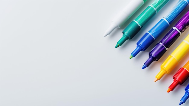 A vibrant array of marker pens laid out on a white surface