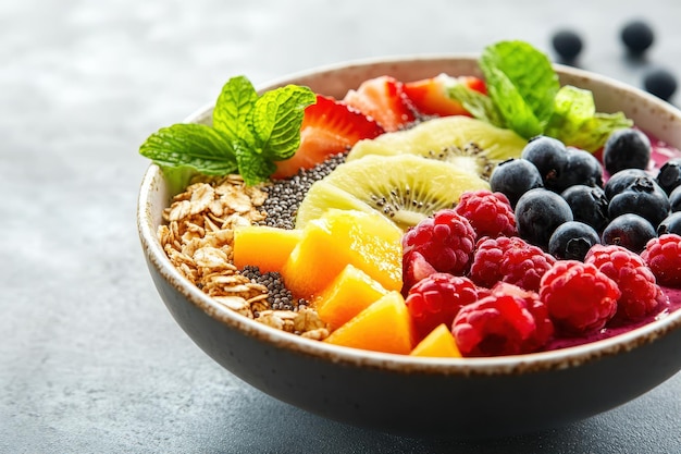 A vibrant bowl of fresh fruit granola and mint perfect for a healthy breakfast or snack Enjoy the colorful and nutritious experience