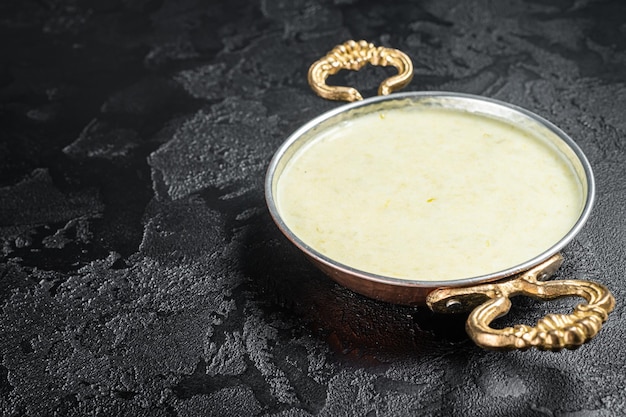 Vichyssoise French cream soup with leek potato and onion Black background Top view Copy space