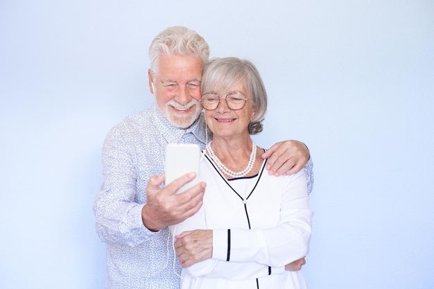 Video call concept Happy senior couple using smartphone together for video chat online communication