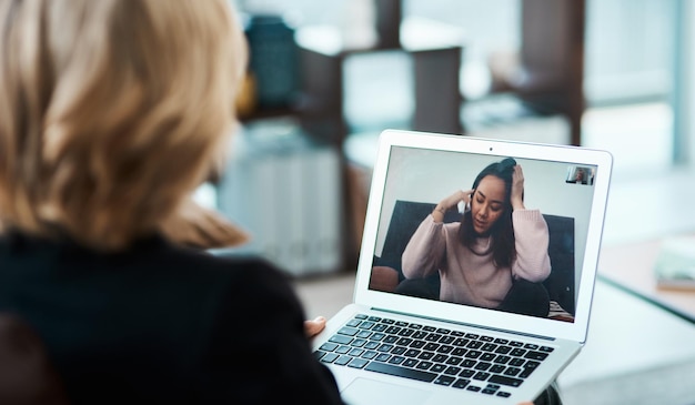 Video call laptop and online therapy by therapist talking to a depressed person with telehealth for anxiety or mental health Virtual psychology and psychologist counseling a woman with depression