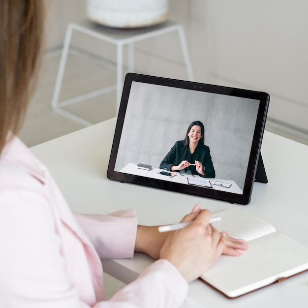 Video call Online meeting Corporate telecommuting Female business partners discussing project working using tablet screen in digital office