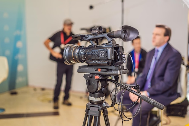 Video camera in conference room recording participants and speake