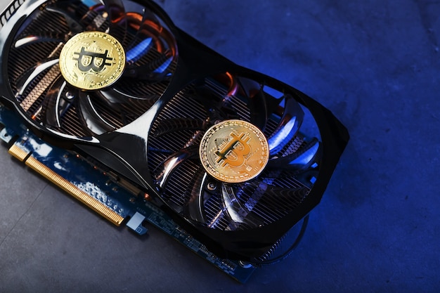 Video card with a gold coin bitcoin on the cooler closeup