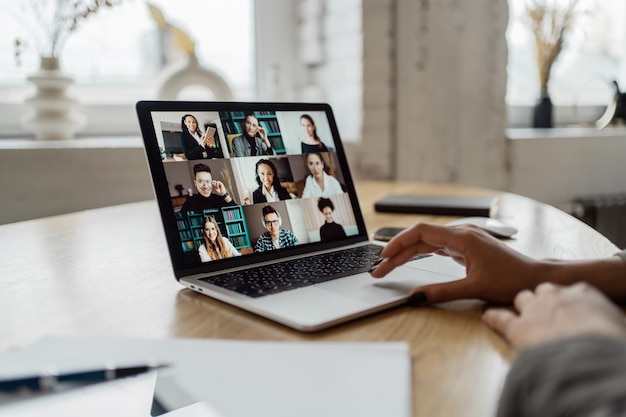 Video communication woman with colleagues freelancer workplace uses laptop computer company report