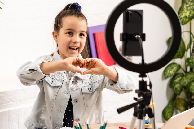 Video streaming. Adorable child learning new technology. Little girl using mobile phone. Small girl child with smartphone. Cute mobile phone technology user. Watching video on mobile device.