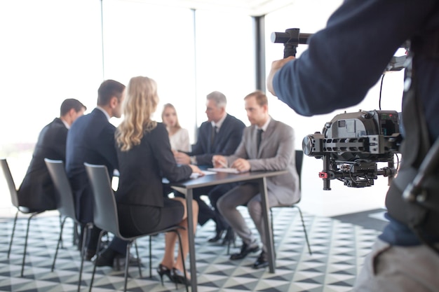 Videographer filming business meeting