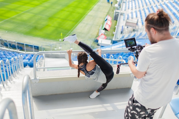 The videographer shoots girl on a professional camera.