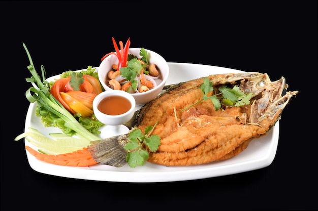 Vietnamese dish Fried fish with sauce green onion tomato