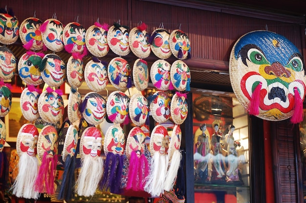 Vietnamese local souvenir gift shop bamboo wicker pannier basket traditional mask painting for sale travelers people in Ba Dinh Old Town Quarter Square at Hoan Kiem on July 7 2012 in Hanoi Vietnam