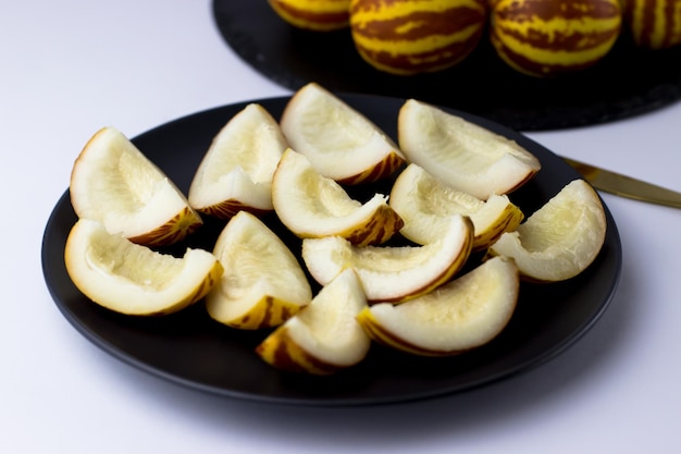 Vietnamese melon close up Whole and cut gourmet miniature tropical fruit and knife Selective focus