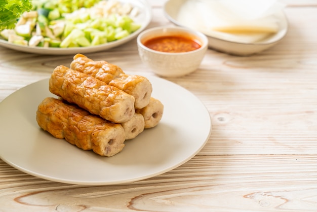 Vietnamese pork meatball with vegetables wraps (Nam-Neaung or Nham Due). vietnamese traditional food culture