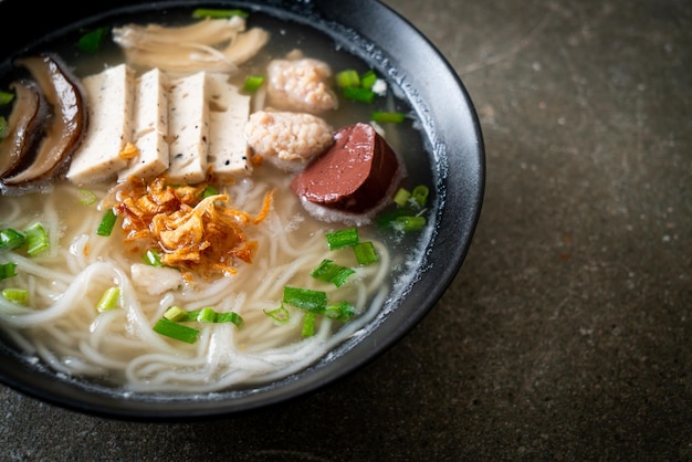 Vietnamese Rice Noodles Soup with Vietnamese Sausage served vegetables and crispy onion