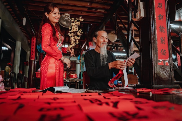 Vietnamese scholar writes calligraphy at Long Son Calligraphy festival is a popular tradition during Tet holiday Writing couplets for Spring Festival new year