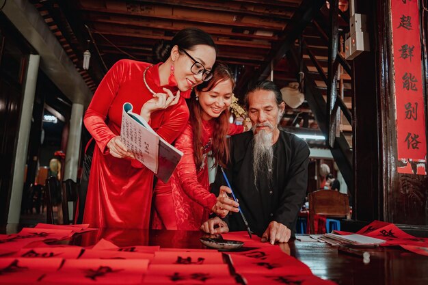 Vietnamese scholar writes calligraphy at Long Son Calligraphy festival is a popular tradition during Tet holiday Writing couplets for Spring Festival new year