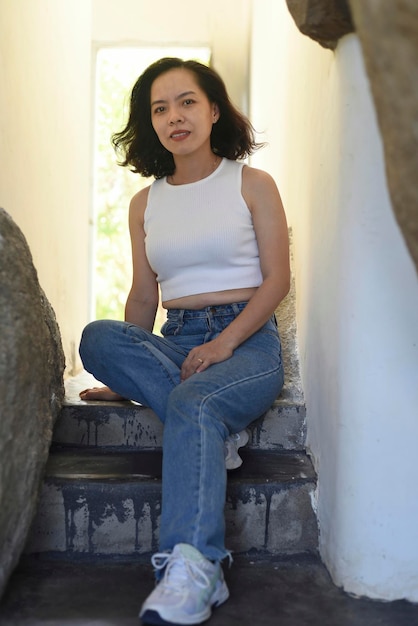 Vietnamese young woman is sitting on steps