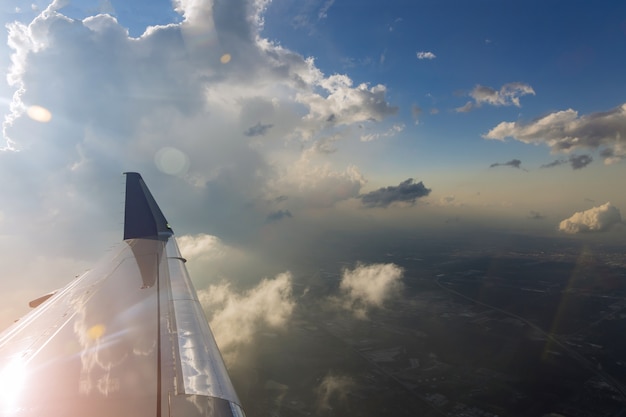 View of the airplane wing during a beautiful colorful cloudy sunset