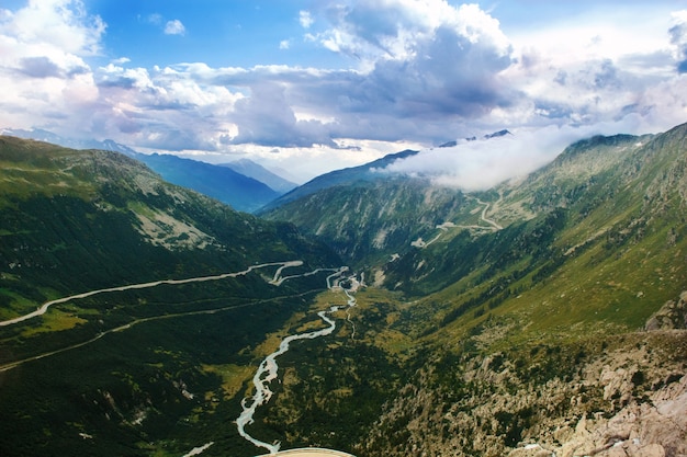 View on Alpine landscape with curved road near Grimselpass