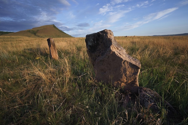 View of ancient burial mounds and menhirs in steppes and mountains of Khakassia