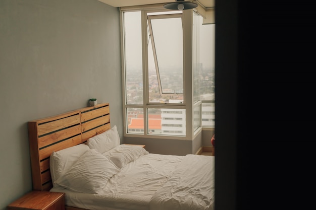 View of apartment bedroom in warm atmosphere from the corner.