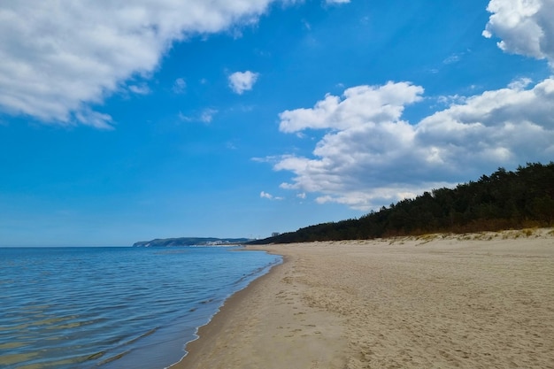 View of the Baltic sandy coast Splashes of water Sunny day on the beach Seascape Change in nature climate