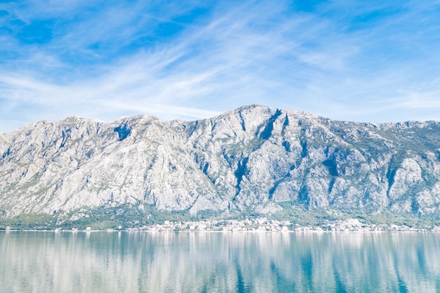 View of Bay of Kotor from the sea surrounded by mountains in Montenegro, one of the most beautiful bay in the world.