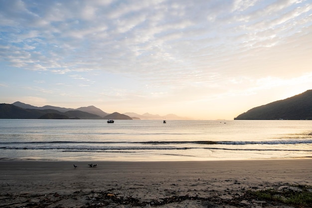 View of beach sand and sea at dawn