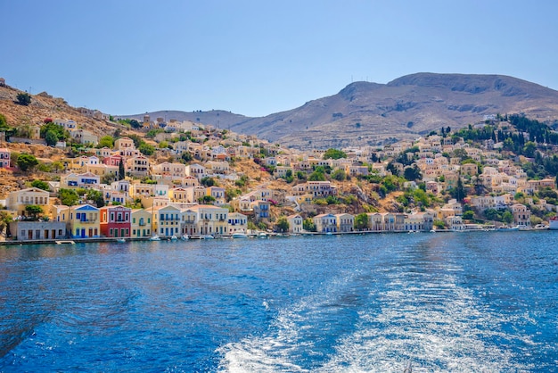 View of beautiful bay with colorful houses on the hillside of the island of Symi Greece