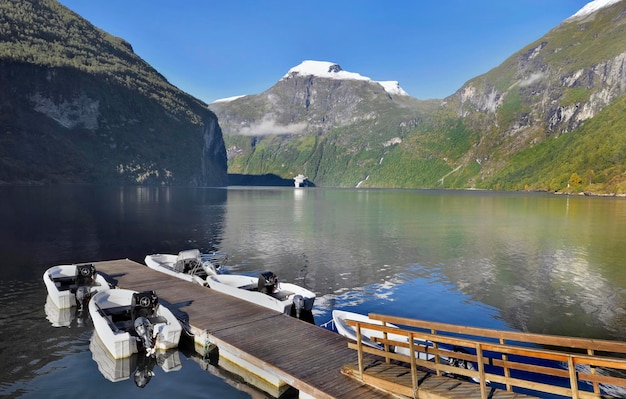 View on beautiful geiranger fjord in Norway with pontoon and bo