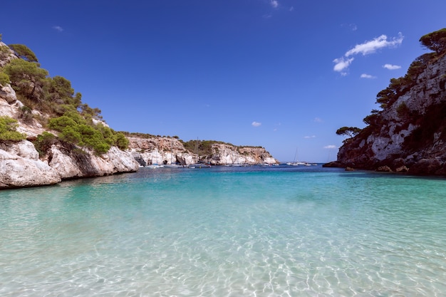 View of the beautiful little beach Cala Macarelleta with clear emerald water of the island Menorca, Balearic islands, Spain