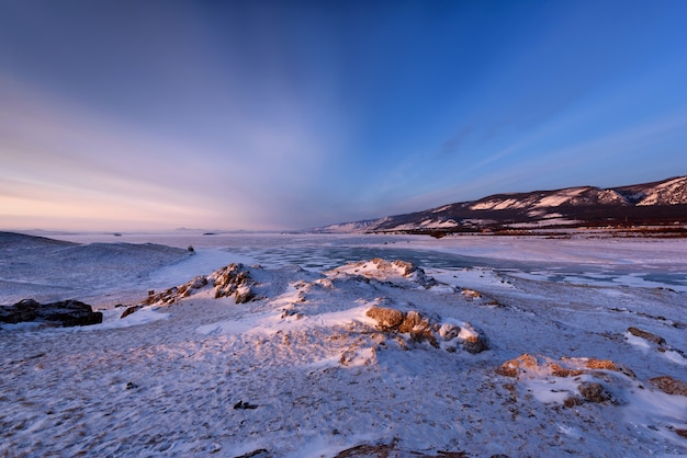 View above big beautiful frozen lake and mountain in winter.